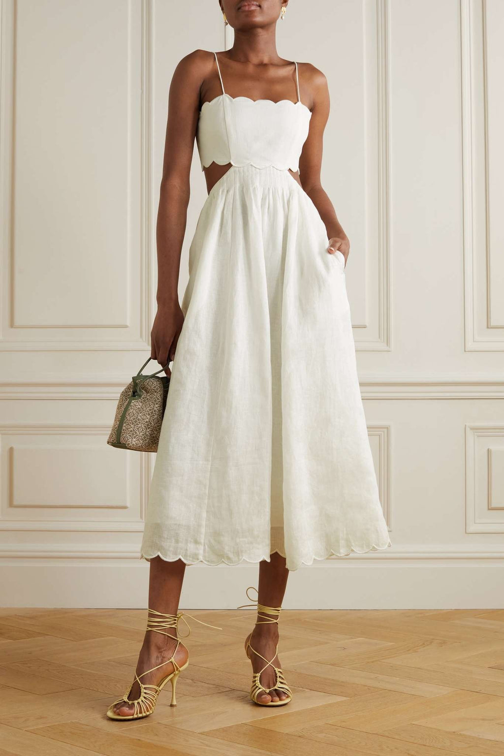 Get ready to turn heads in the Jude Scalloped Linen Midi Dress by Zimmermann! Made from airy linen-voile, this dress is detailed with delicate scalloped trims and cutout sides for a stylish touch. The adjustable straps and shell-embellished lace-up ties at the back ensure a perfect fit. Embrace effortless elegance with this must-have dress!
