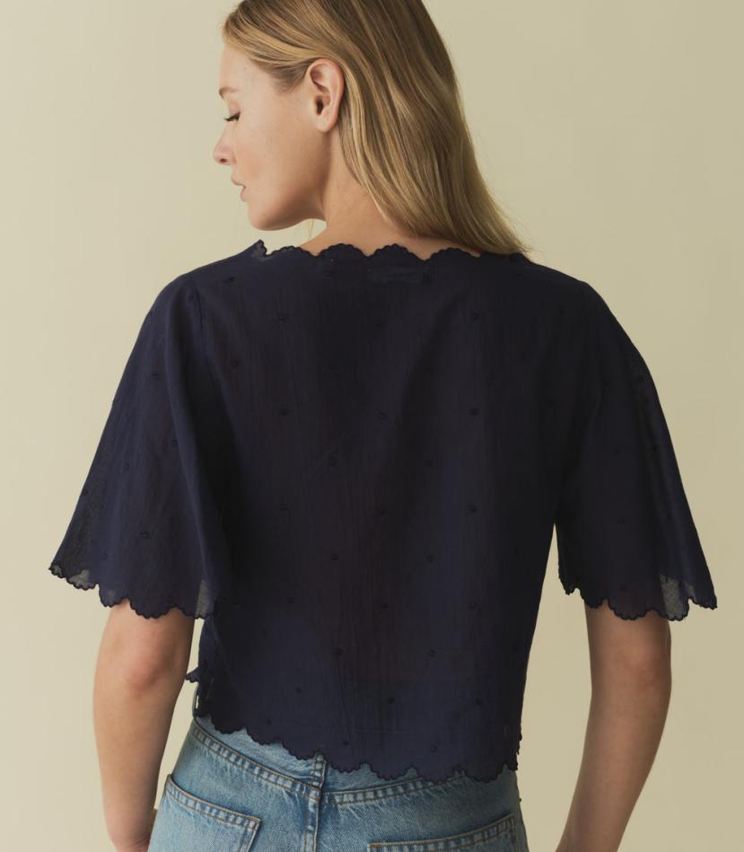 The Kacy Top by DOEN blends vintage charm with modern elegance. Crafted in 100% organic cotton voile, this blouse features charming cutouts, delicate bow embroidery, and breezy elbow-length sleeves. With scalloped details and delicate dot embroidery, this top is a playful yet sophisticated addition to your wardrobe.