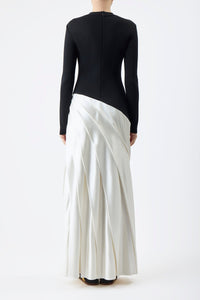 Indulge in luxury with the Ismay Silk Pleated Maxi Dress by Gabriela Hearst. This elegantly crafted piece boasts a clever design, featuring a black silk knitted bodice and a white pleated satin skirt for a striking contrast. The sharp pleats create beautiful movement as you walk, while the mock neckline adds a touch of sophistication. Perfectly paired with classic pumps for a timeless look.