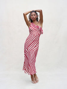 Indulge in the timeless charm of Theodora Maxi Dress. Its one-shouldered design and silk candy stripes evoke a sense of theatrical elegance. Panelled seams create an abstract stripe pattern in cream and deep red hues. Cinch the waist for added allure and pair with a dark lip and pointed heels for a touch of old-school Parisian chic.