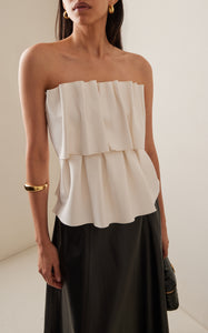 Expertly crafted from smooth stretch-crepe, the Sculpted Tube Top by House of Dagmar is a must-have for any fashion-forward individual. The strapless design boasts a gathered bust for a uniquely ruffled effect, adding a touch of effortless elegance to any outfit. Experience the perfect blend of style and comfort with this versatile top.