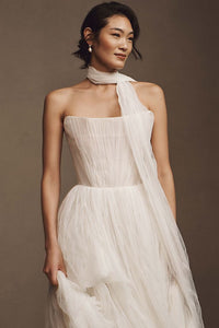 Elevate your wedding day look with the Klelia Gown. Its soft netting, Georgian-style corsetry, and delicate tucks exude both romance and structure. Contemporary style meets timeless charm in the ballgown silhouette, while modern design sensibilities add a touch of uniqueness. Make a statement on your special day with this reimagined classic.