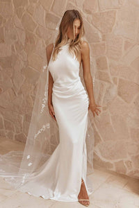 Dress Goldie is the perfect choice for modern brides. Featuring a stunning halter neckline and sleeveless design, this simple mermaid wedding dress is made of high-quality satin material and boasts an open back and high side slit for added elegance. With its floor length, it's sure to make a lasting impression on your special day.