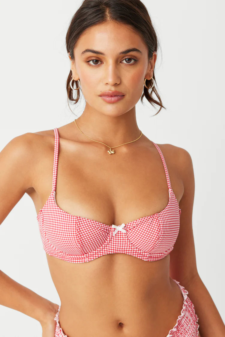 Indulge in the trendy and chic Sofie Bikini Set. This two-piece set features a slimming elastic waistband and flattering low-rise fit, perfect for any beach babe. The stretchy smocking textures and Ladybug Gingham print add a touch of style to this must-have bikini!