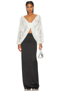 "Elevate your style with our Milk White Blouse Madeline. This sophisticated top boasts floral applique for a subtle, feminine touch and chic batwing sleeves. A must-have for any exclusive event or night out, this wrap lace top, handcrafted by Giussepe di morabito with %100 premium material, exudes luxury and class."