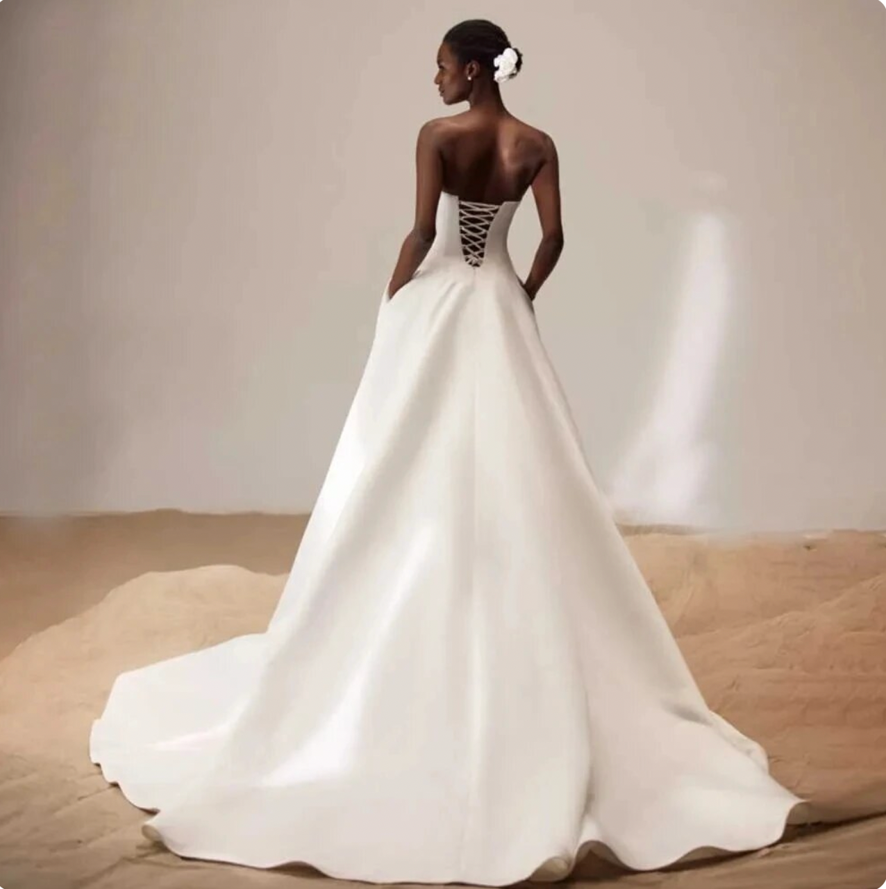 Elevate your bridal style with Dress Kara. Its sexy strapless and backless design exudes sophistication, while the smooth satin fabric adds a touch of luxury. The lace-up closure ensures a perfect fit, making you feel confident and beautiful on your special day. A must-have for any modern bride.