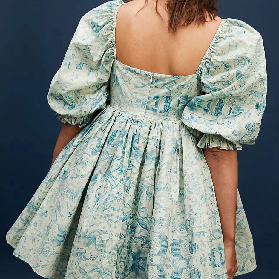 The Dorothy Dress is a must-have for any fashion-forward wardrobe. With its on-trend puff sleeves and flattering square neckline, it highlights your best features. The playful ruffle hem adds a touch of femininity, while the bold print ensures you'll make a statement wherever you go.