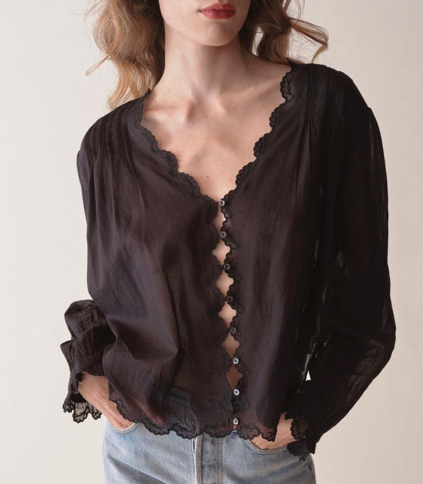 Introducing the Elayne Top from Doen, made from the softest organic cotton voile. This fan-favorite style features a plunging V-neck, double scallop sleeves, and an adjustable back waist tie for the perfect fit. Playful cutouts and mother-of-pearl buttons add a touch of whimsy, while pintucks create texture and dimension. Look and feel effortlessly beautiful in this must-have top.