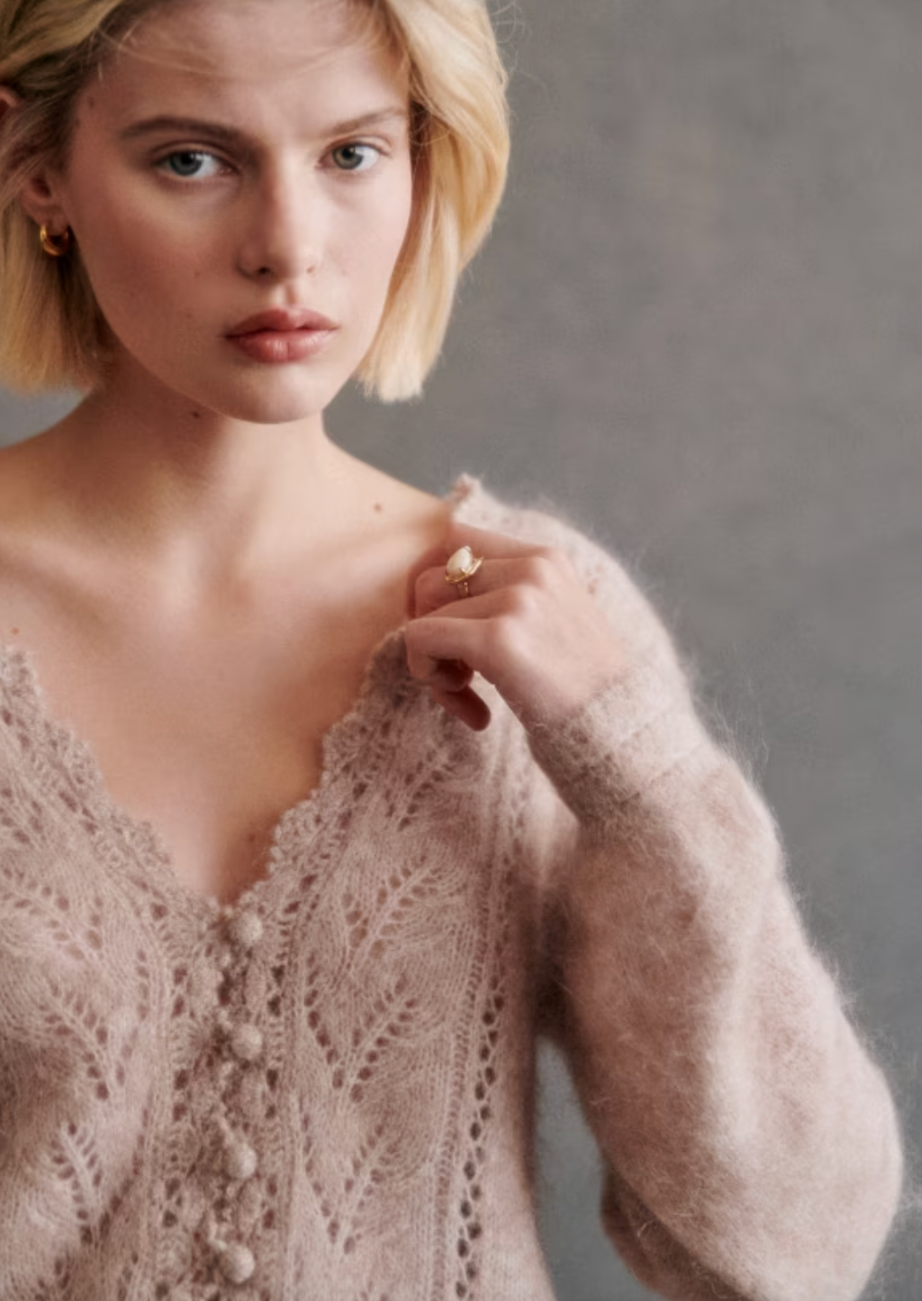 This cardigan is expertly crafted with kid mohair and merino wool for a soft and luxurious feel. The long balloon sleeves and open knit design add a touch of elegance, while the crochet finish along the button placket and neckline create a unique and sophisticated look. With a classic v-neckline and crochet buttons, this cardigan is both stylish and versatile.