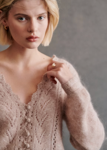 This cardigan is expertly crafted with kid mohair and merino wool for a soft and luxurious feel. The long balloon sleeves and open knit design add a touch of elegance, while the crochet finish along the button placket and neckline create a unique and sophisticated look. With a classic v-neckline and crochet buttons, this cardigan is both stylish and versatile.