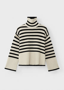 Unleash your fashion-forward style with the Striped Wool Jersey by Toteme. Crafted from heavyweight wool and organic cotton, this turtleneck sweater boasts a striking sand and black striped pattern. Certified by the Responsible Wool Standard, its boxy silhouette, tall neck, and extra-long sleeves with dropped shoulders exude luxury and sophistication. Leave the neck undone for an effortlessly chic look.