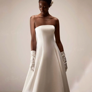 Elevate your bridal style with Dress Kara. Its sexy strapless and backless design exudes sophistication, while the smooth satin fabric adds a touch of luxury. The lace-up closure ensures a perfect fit, making you feel confident and beautiful on your special day. A must-have for any modern bride.