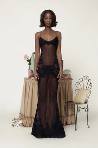 The Anemone Gown Noir is a work of art, featuring hand cut and sewn lace appliqués along the neckline, hip, and hem. Reinforced with horsehair, the gown cascades gracefully and offers an elegant silhouette. Imported laces from France add to its luxurious design. Hook and eye closure ensures a perfect fit, while the removable lining allows for versatile wear.