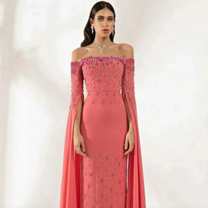 This Robe Leelie mermaid evening gown features stunning coral pink accents sparkled throughout. Its intricate detailing creates a beautiful and sophisticated look that's perfect for any formal occasion.