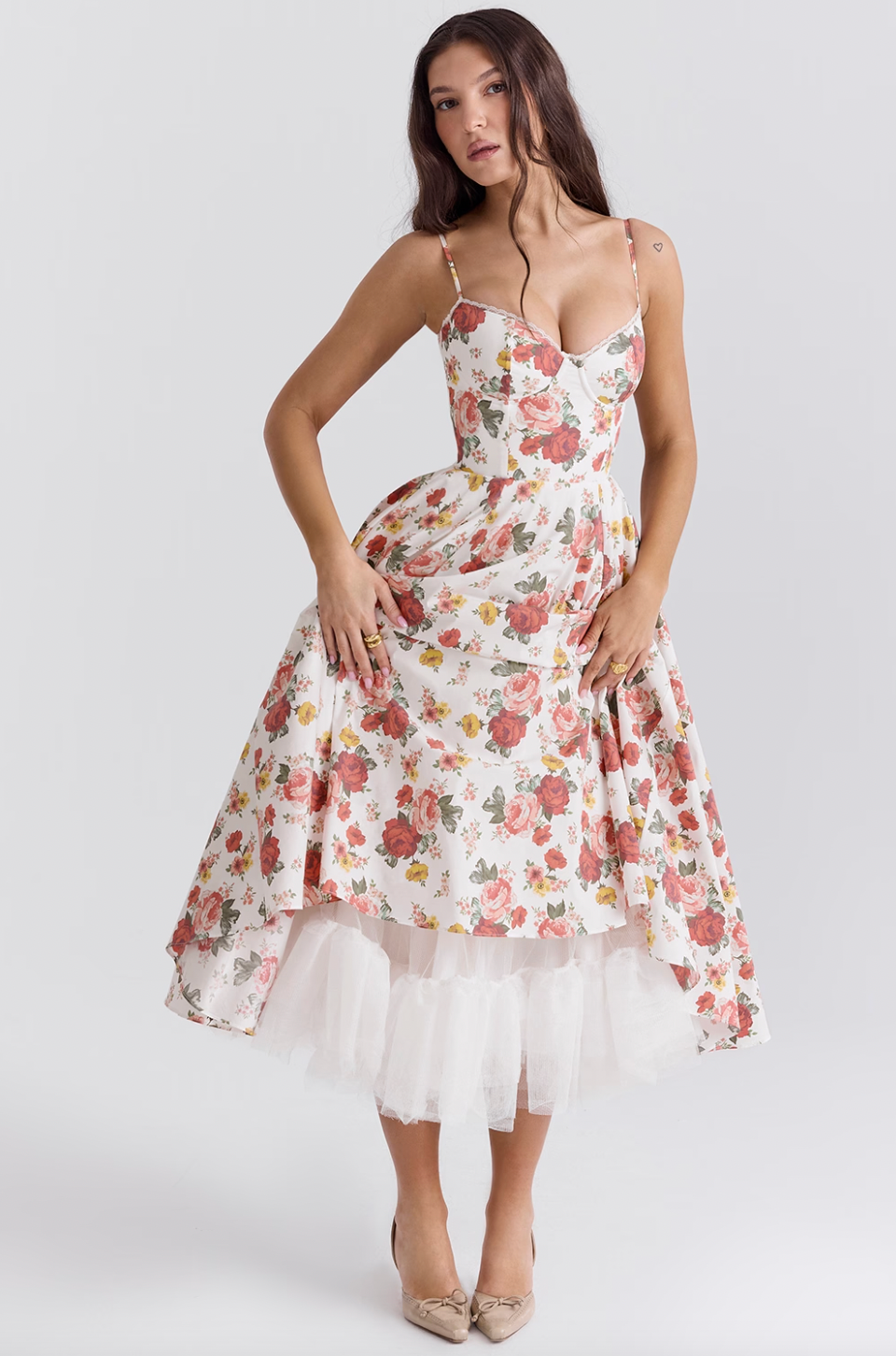 Indulge in the enchanting beauty of the Italian Rose Midi Dress. With a boned bodice, sweetheart neckline, and delicate adjustable straps, this dress cinches your waist and flatters your figure. The floaty midi skirt, featuring a voluminous layer of soft tulle, exudes an elegant and ethereal charm.