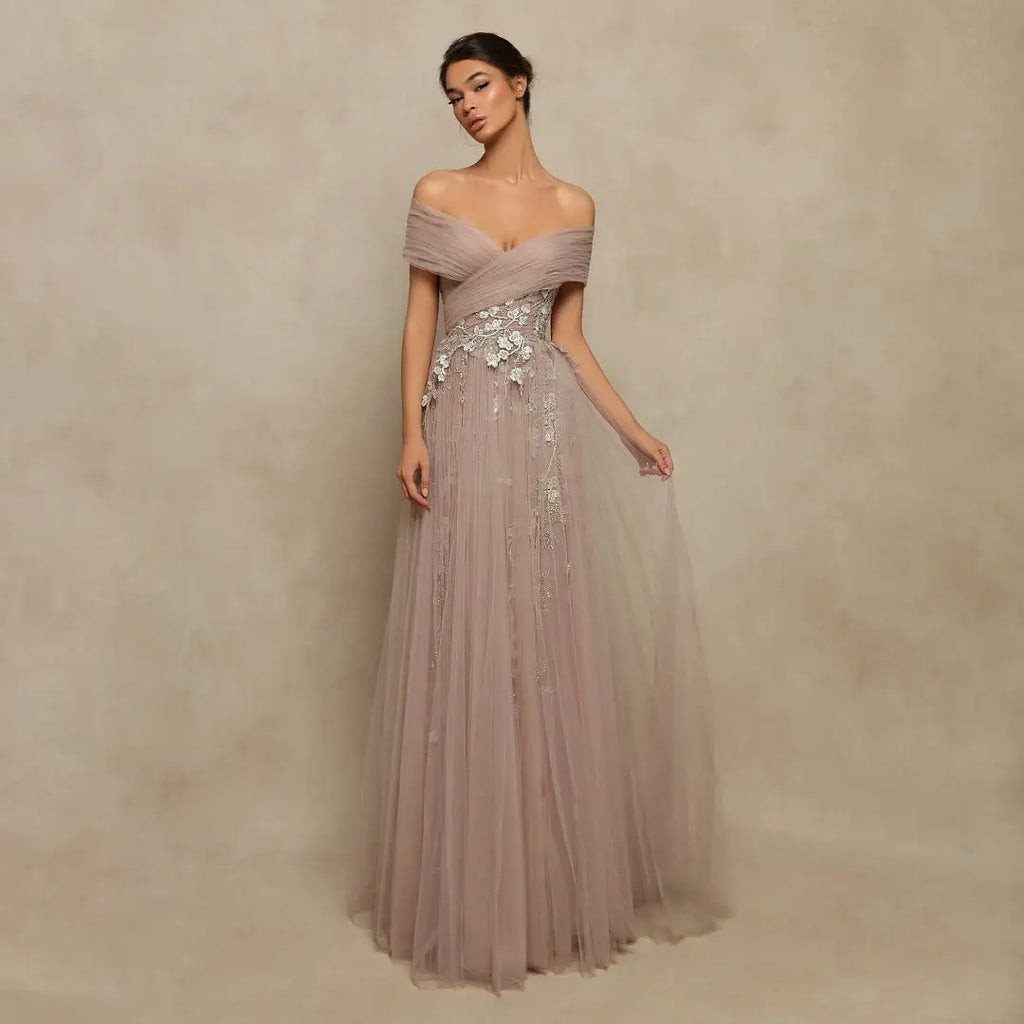 Elevate your style game with the Lenora Off The Shoulder Gown. This vintage-inspired prom dress features delicate tulle fabric, stunning appliques, and intricate beading, creating a unique and bold look. With its off-the-shoulder design, you'll feel daring and confident, ready to make a statement at any special occasion.