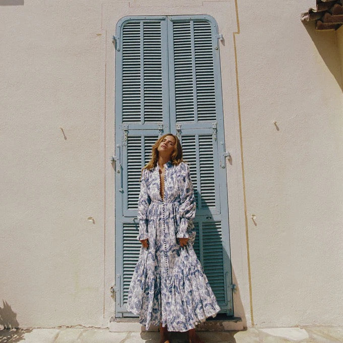 Be the center of attention at your next event with our Royal Flush Dress. Made from 100% Linen Scallop, this maxi dress features a unique Jungle Blue print, functional buttons, and blouson sleeves with elasticated cuffs. Complete the look with the included eyelet belt. Expertly crafted for a statement-making look.