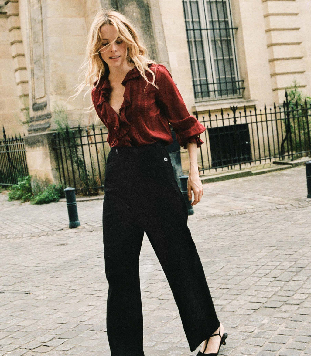 Elevate your style with the Hardy Top in Deep Crimson by Doen! This chic and sophisticated blouse features full sleeves, a delicate ruffle, and mother of pearl buttons. Its 1970s-inspired pintucked design exudes French girl charm. Perfect for any occasion, this versatile blouse adds a touch of elegance to your wardrobe.