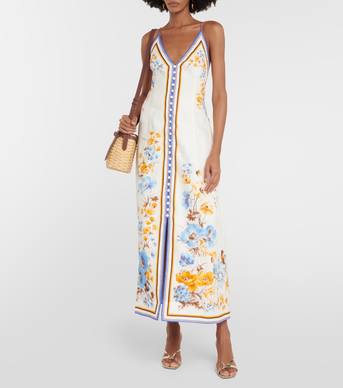 The Emy Midi Dress showcases whimsical, iconic floral prints that add a touch of playfulness to any wardrobe. Crafted from lightweight linen, this dress features a buttoned front placket and crossover shoulder straps for a sophisticated yet comfortable look. Elevate your style with this chic and versatile piece.