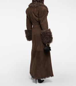 Stay cozy and stylish this winter with our Charlize Suede Coat. This luxurious coat features a soft fur leather exterior, belted waist, and warm lambswool lining. The long sleeve design, turndown collar, and multiple pockets make it both practical and fashionable. Don't sacrifice comfort for style - stay warm and chic with our plush overcoat.