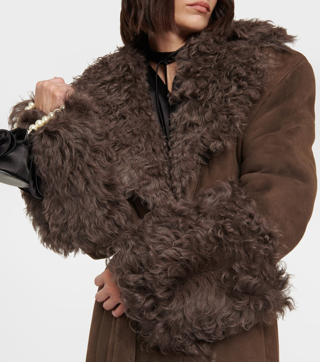 Stay cozy and stylish this winter with our Charlize Suede Coat. This luxurious coat features a soft fur leather exterior, belted waist, and warm lambswool lining. The long sleeve design, turndown collar, and multiple pockets make it both practical and fashionable. Don't sacrifice comfort for style - stay warm and chic with our plush overcoat.