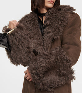 Stay cozy and stylish this winter with our Charlize Suede Coat. This luxurious coat features a soft fur leather exterior, belted waist, and warm lambswool lining. The long sleeve design, turndown collar, and multiple pockets make it both practical and fashionable. Don't sacrifice comfort for style - stay warm and chic with our plush overcoat.