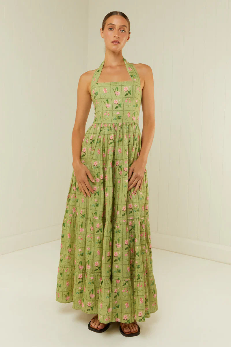 The Willow Dress by Palm Noosa is made from high-quality linen and showcases our unique Green Floral Tile print. Its halter neck design and flowing skirt provide a flattering fit, while the elasticated back panel ensures comfort. For detailed fit information, please consult our size guide. Enjoy effortless style with the Willow Dress.