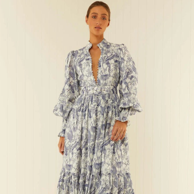 Be the center of attention at your next event with our Royal Flush Dress. Made from 100% Linen Scallop, this maxi dress features a unique Jungle Blue print, functional buttons, and blouson sleeves with elasticated cuffs. Complete the look with the included eyelet belt. Expertly crafted for a statement-making look.