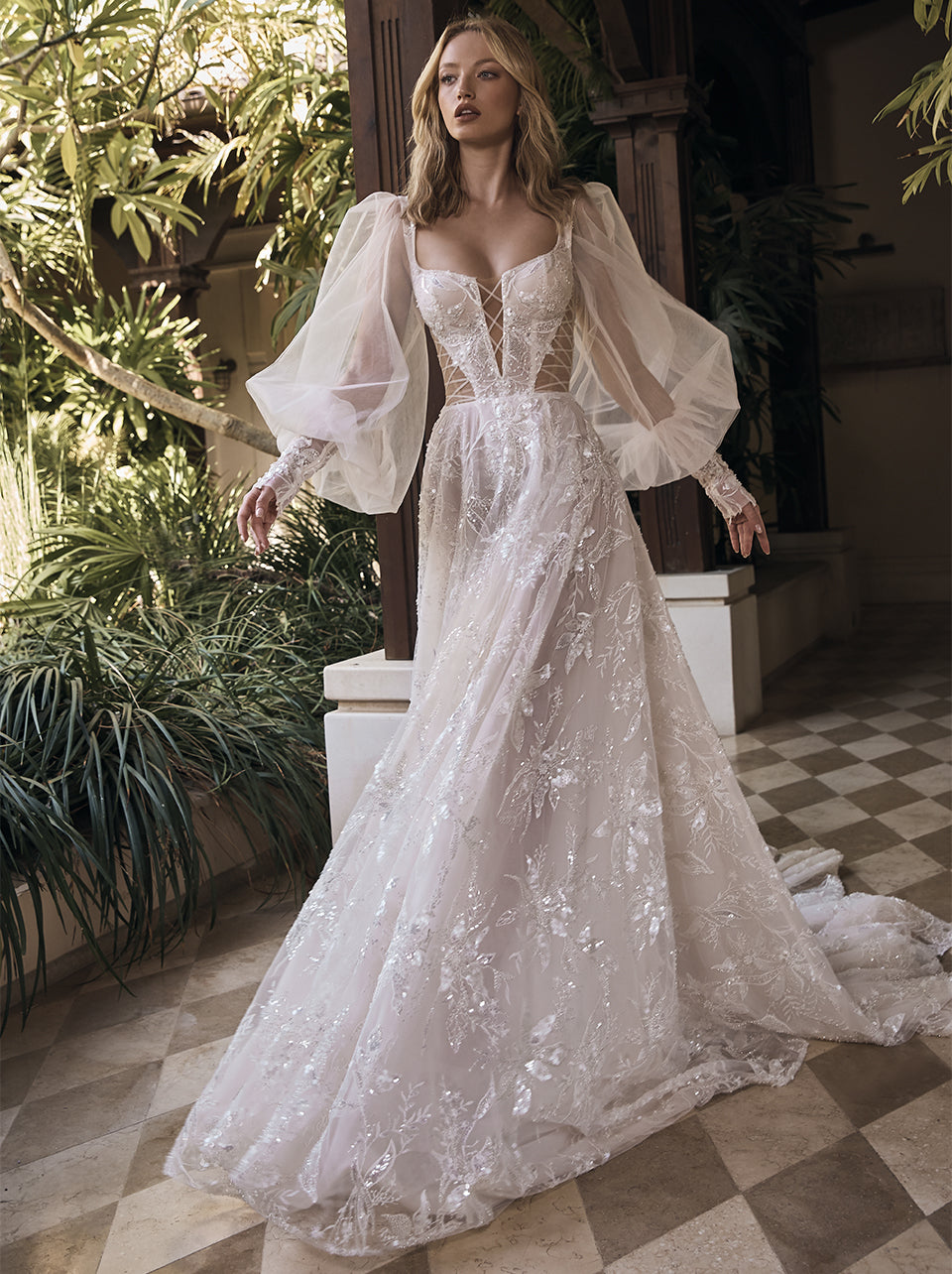 Showstopping sheer lantern sleeves aren't the only wow-worthy aspects of this dreamy wedding dress. The romantic A-line silhouette, fitted corset top with square neckline, cutout details, and lace embellishments make Pipa an undeniably chic option—finished in an embroidered ivory and silver tulle.