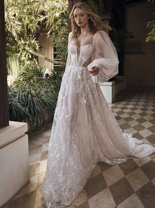 Showstopping sheer lantern sleeves aren't the only wow-worthy aspects of this dreamy wedding dress. The romantic A-line silhouette, fitted corset top with square neckline, cutout details, and lace embellishments make Pipa an undeniably chic option—finished in an embroidered ivory and silver tulle.