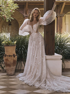 Showstopping sheer lantern sleeves aren't the only wow-worthy aspects of this dreamy wedding dress. The romantic A-line silhouette, fitted corset top with square neckline, cutout details, and lace embellishments make Pipa an undeniably chic option—finished in an embroidered ivory and silver tulle.