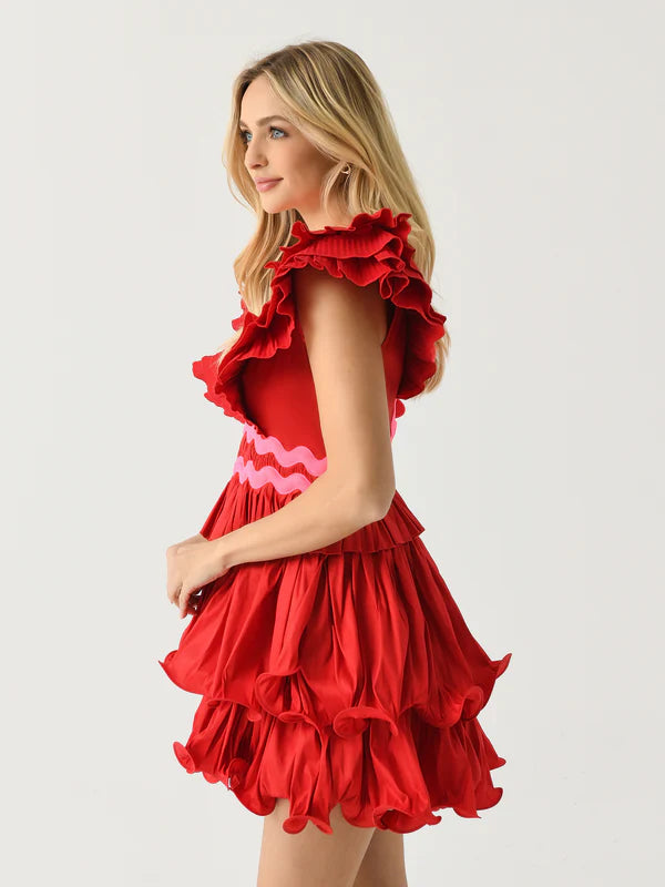 The Prisma Dress is a must-have for any fashion-forward individual. With a pleated design and voluminous sleeves, this dress exudes elegance and sophistication. The layered flounce skirt adds a touch of drama, while the contrasting ric-rac trims add a playful touch. Stand out from the crowd with this statement piece.