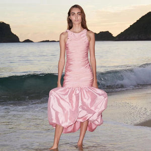 The Bahia Dress is perfect for any occasion with its beautifully crafted sleeveless design and light pink bundage satin material. Its mermaid silhouette will flatter any figure, and the open back adds a touch of elegance. The cascading folds and maxi length make this dress a timeless choice for any woman's wardrobe.