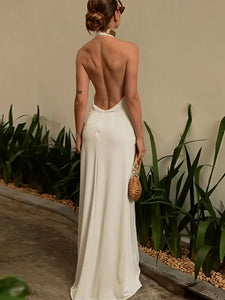 Indulge in luxury with the Dress Safiya. This stunning maxi dress features a seductive backless design, halter neckline, and pleated detailing. With a deep V-neck and sleeveless cut, this dress exudes sophistication and sensuality. Elevate your fashion game and turn heads at any event with this elegant and exclusive piece.