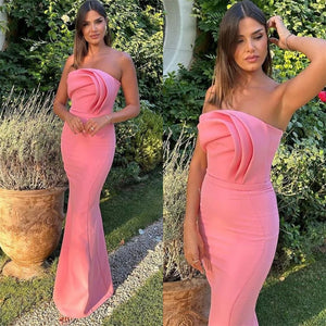 The Arleen Gown exudes luxury and elegance with its simple strapless design, sheath silhouette, and fold satin fabric. Perfect for any special occasion, this cocktail dress is accented with beautiful flowers for a touch of femininity. Add this stunning gown to your evening wear collection.