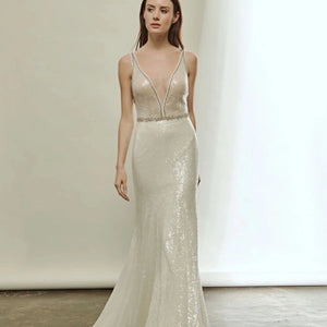 Indulge in the luxurious allure of the Robe Ivonne. This stunning wedding dress features a sexy deep V-neck and a backless design, perfect for showcasing your curves. Embellished with sparkly sequins, this robe exudes elegance and grace. Slip into this mermaid style gown and feel like a glamorous bride on your special day.