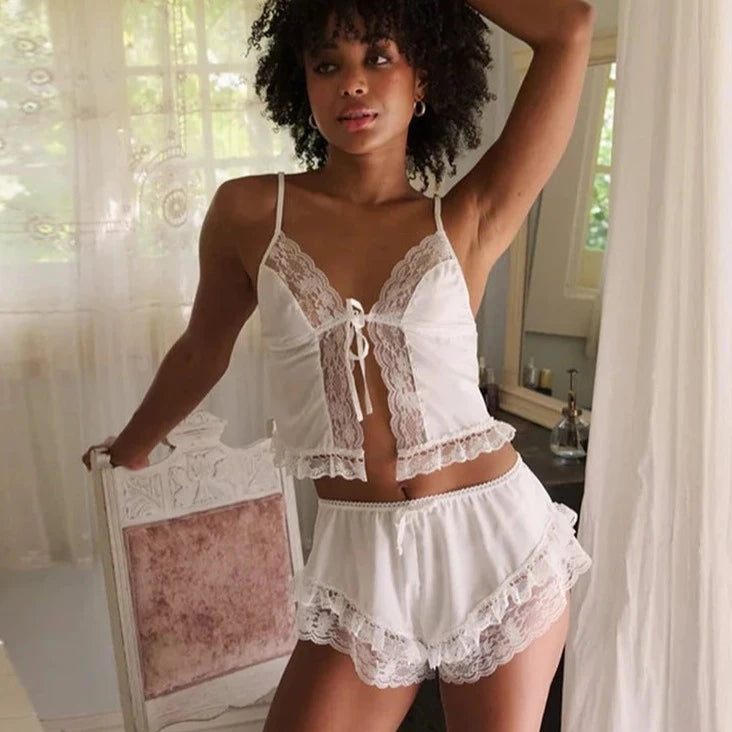 The Harriette Set in White is the perfect combination of vintage charm and modern comfort. Crafted with soft fabric and delicate lace details, this set features a front tie camisole and elastic waist shorts that flatter every body shape. Get ready to feel confident and stylish in this must-have set.