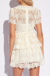 Introducing Flower Lace Mini Dress by Self-Portrait - a reimagined classic for the modern woman. Embodying a signature sensuality and ease, this elegant dress features delicate lace embroidery, feminine short sleeves, and a flattering v-neck. Complete with a sash for added style, it's perfect for any summer occasion.