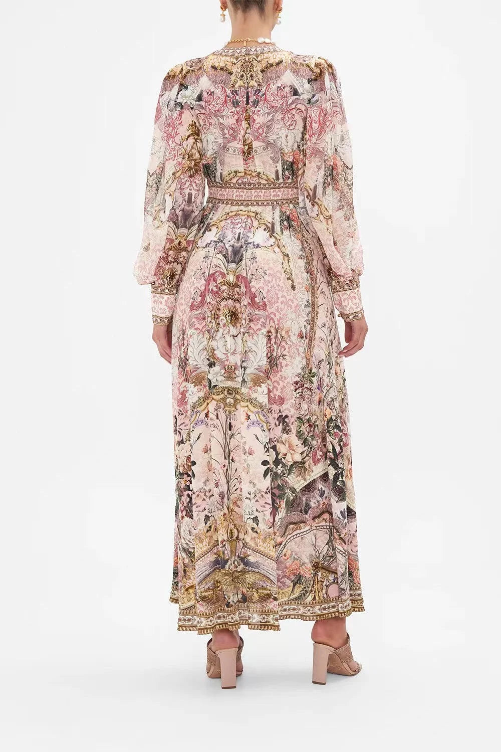 Upgrade your wardrobe with the elegant Bambino Bliss Silk Dress. Made with a vintage pink flower pattern and luxurious silk print, this dress exudes sophistication. The deep V neck and lantern sleeves add a touch of glamour while the gold buttons give it a classic touch. Perfect for any formal occasion.