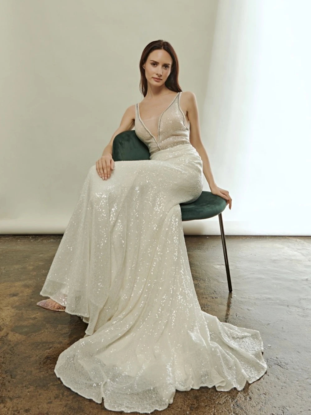 Indulge in the luxurious allure of the Robe Ivonne. This stunning wedding dress features a sexy deep V-neck and a backless design, perfect for showcasing your curves. Embellished with sparkly sequins, this robe exudes elegance and grace. Slip into this mermaid style gown and feel like a glamorous bride on your special day.