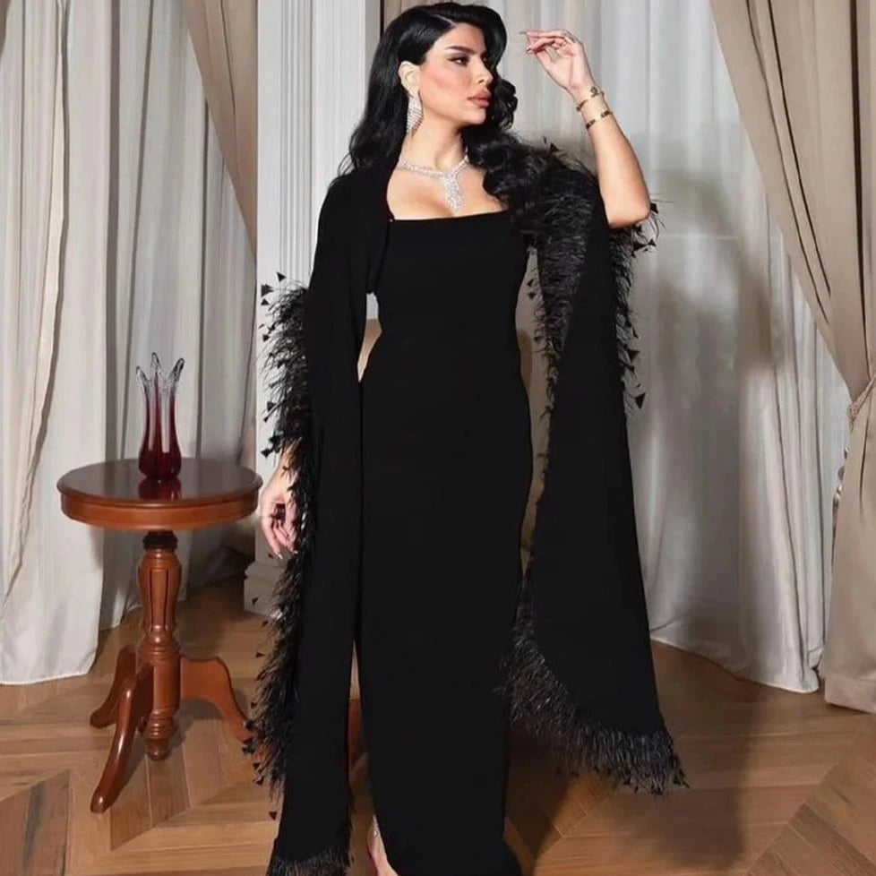 The Adamaris Dress offers a luxurious and elegant look with its trumpet sleeves, square neckline, and sleek black design. Perfect for prom or any special occasion, this dress exudes a sophisticated and sexy vibe. Elevate your style with this statement piece.