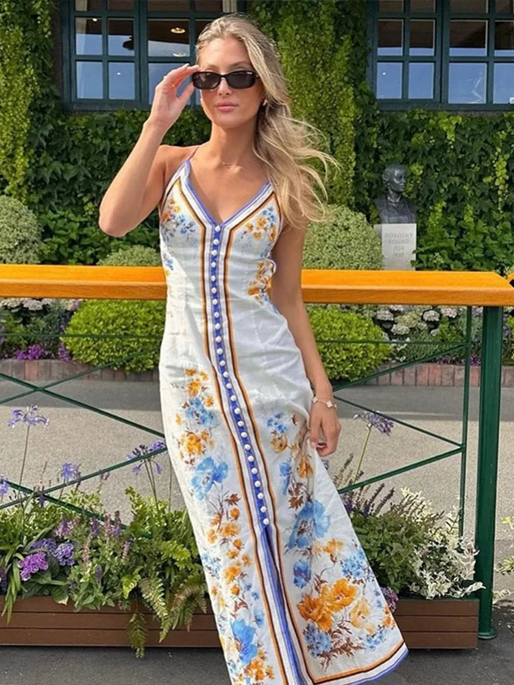 The Emy Midi Dress showcases whimsical, iconic floral prints that add a touch of playfulness to any wardrobe. Crafted from lightweight linen, this dress features a buttoned front placket and crossover shoulder straps for a sophisticated yet comfortable look. Elevate your style with this chic and versatile piece.