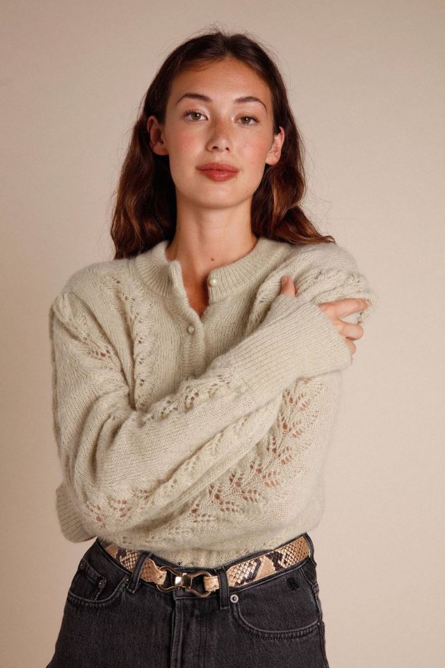 Indulge in the luxury of our Maddy cardigan. This intricately knitted piece features a delicate lace design, a round neckline, and long sleeves. The scalloped edges add a touch of elegance to the button details. Stay stylish and cozy with this must-have addition to your wardrobe.