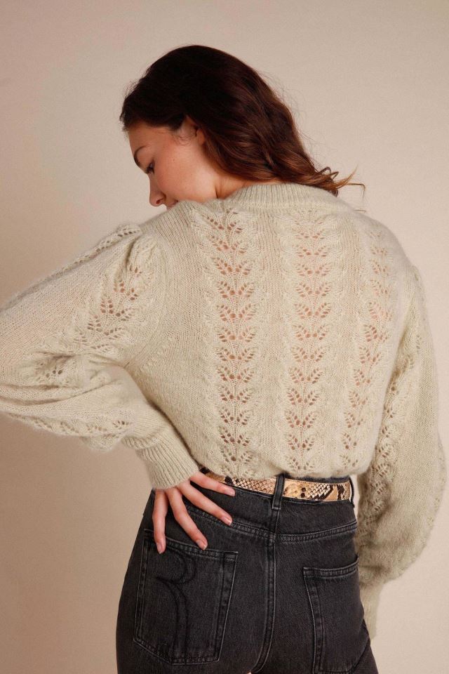 Indulge in the luxury of our Maddy cardigan. This intricately knitted piece features a delicate lace design, a round neckline, and long sleeves. The scalloped edges add a touch of elegance to the button details. Stay stylish and cozy with this must-have addition to your wardrobe.