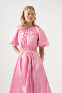 Indulge in sophistication with the Capucine Puff Sleeve Midi Dress by Aje. Featuring a fitted bodice with a stunning waist cut-out and braided edging, this dress flatters your figure. The short puff sleeves and gathered skirt add elegance and practicality with side pockets and a zip and snap button closure.