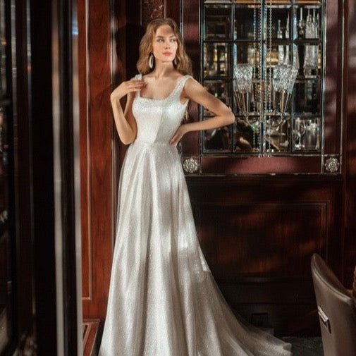 Discover elegance and sparkle with our Robe Jackaline. This bridal gown exudes sophistication and adds a touch of glamour to any special occasion. With its sparkling details, it's the perfect choice for brides looking for a timeless and elegant look. Elevate your style with the Robe Jackaline.