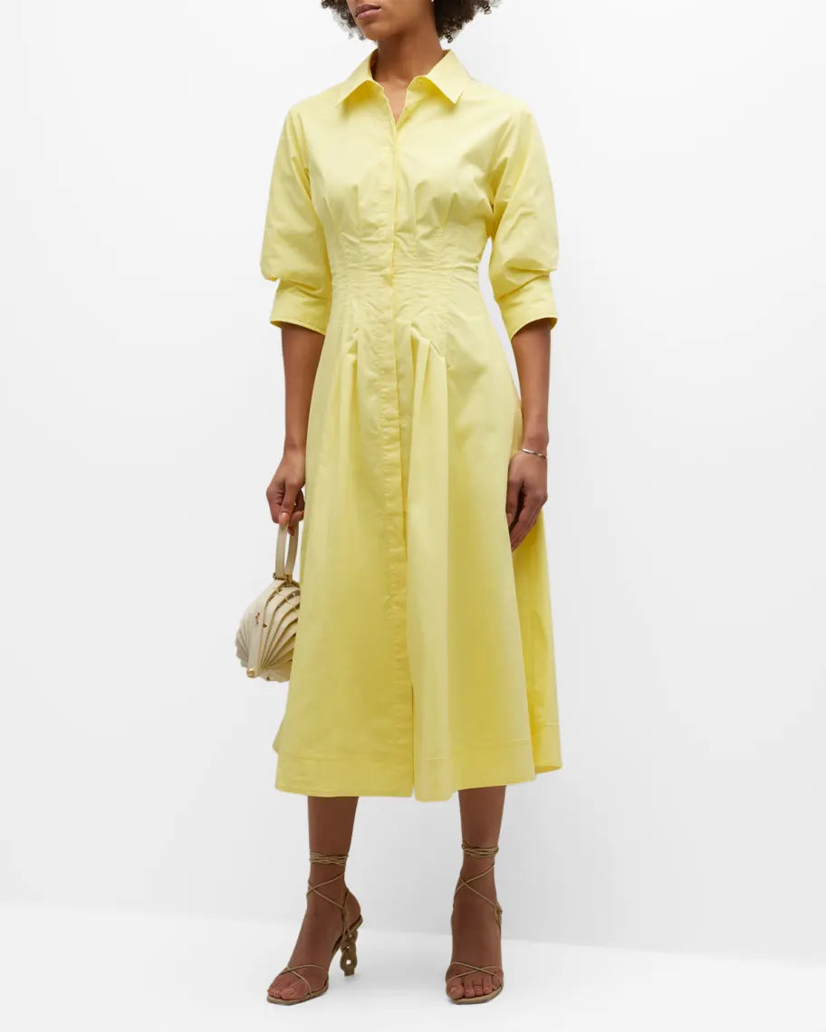 Expertly crafted from a cotton blend, the Jazz Cotton Poplin Pintuck Midi Shirtdress by Simkhai features pintuck detailing on the flared skirt, a straight-point collar, and concealed front button fastening for a modern yet classic look. With three-quarter length puff sleeves and a full lining, this midi-length dress is both comfortable and stylish.