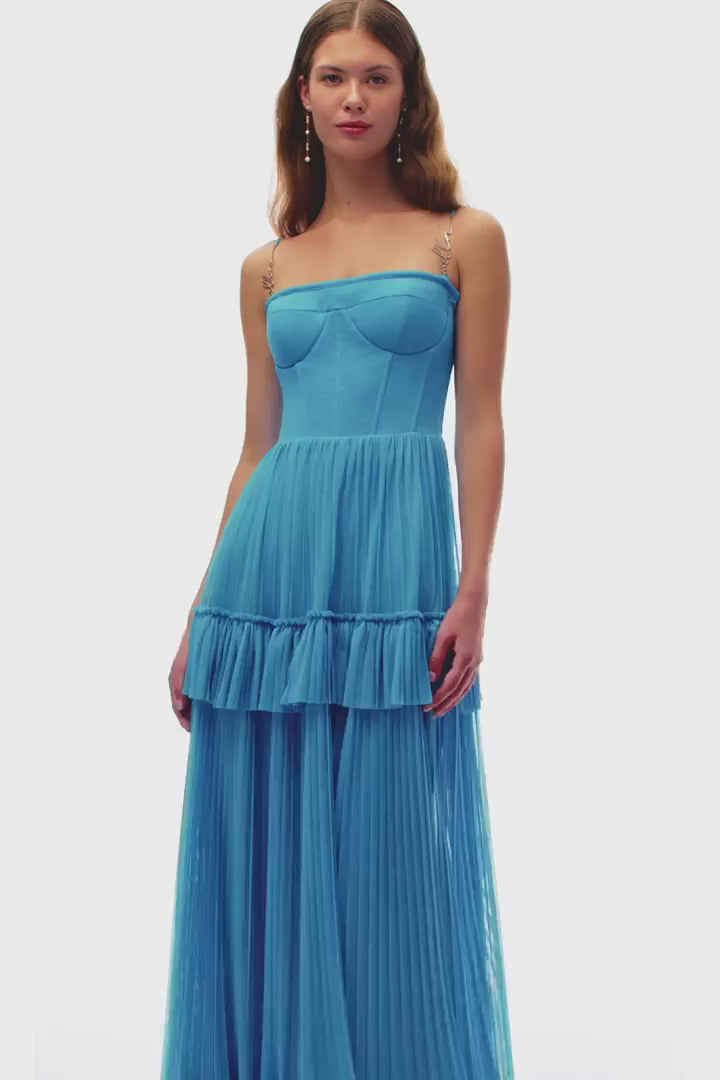 Indulge in elegance with the Eden Maxi Dress. The sky-blue mesh fabric creates a graceful silhouette with a structured boned bustier bodice, adorned with delicate spaghetti straps. The pleated A-line maxi skirt adds a touch of sophistication to your every step. Perfect for any special occasion.