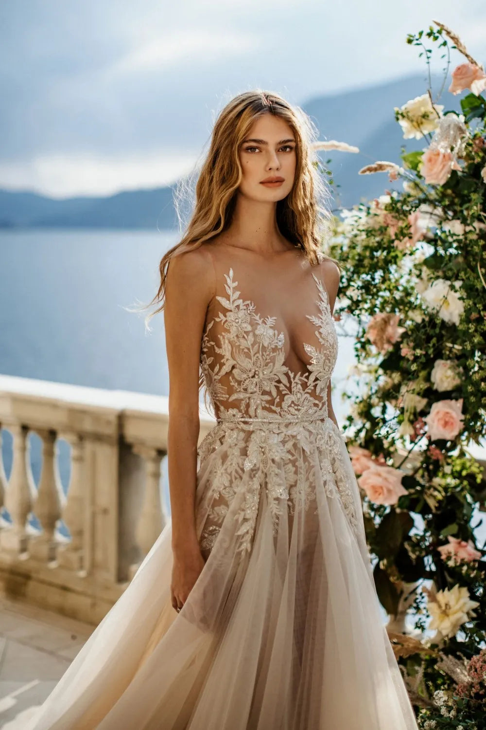 Make a timeless statement with the Robe Joanne, a beautiful bridal gown featuring a renaissance princess silhouette and delicate floral lace. This exquisite design has a timeless elegance that will elevate your wedding day look. Luxurious and timeless, you'll be the picture of sophistication on your special day.