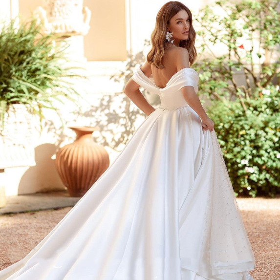 Introducing the Robe Saverine, a stunning a-line wedding gown handcrafted with exquisite French satin. Elevate your special day with this elegant and luxurious dress, designed to make you feel like a work of art walking down the aisle. Embrace the beauty of simplicity and sophistication with this one-of-a-kind piece.